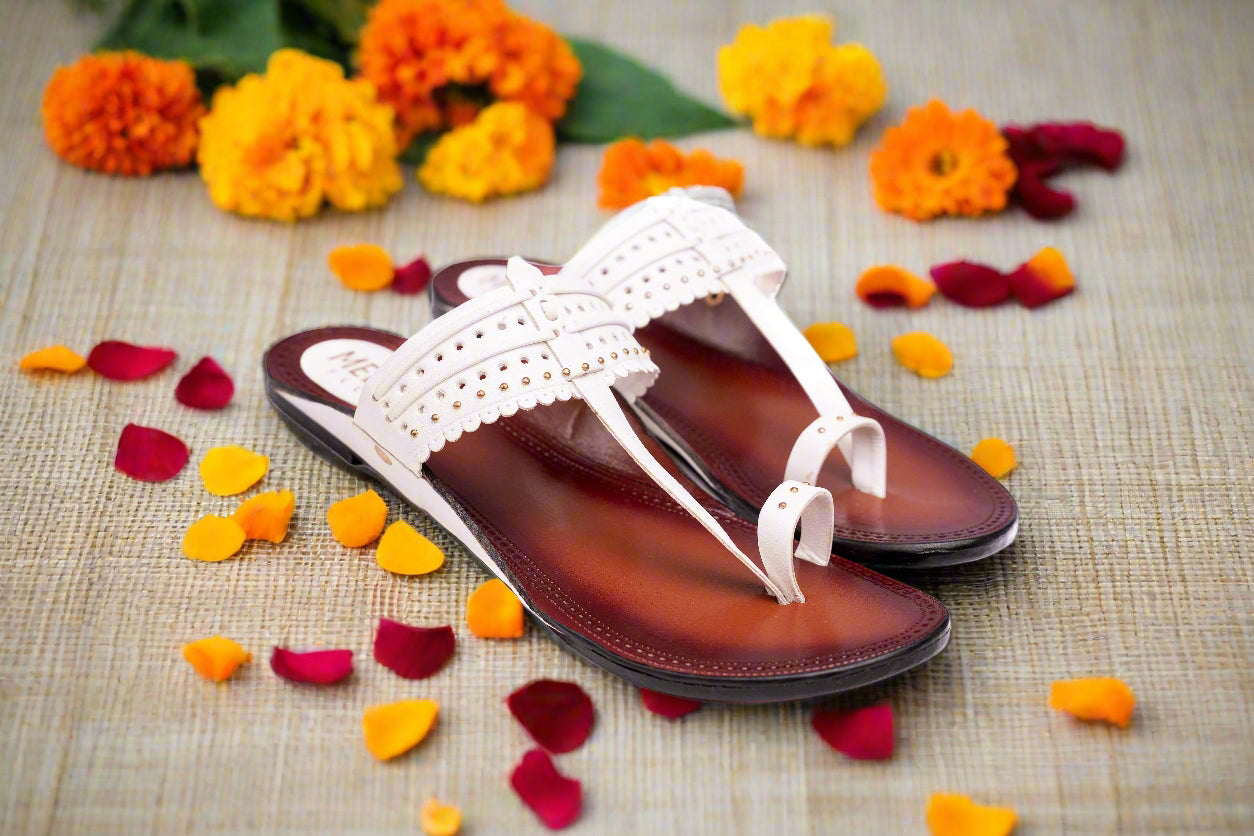 Pair of brown and white sandals on a white background