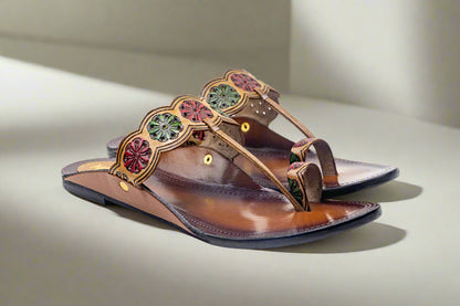 Brown sandal with decorative straps on a white background