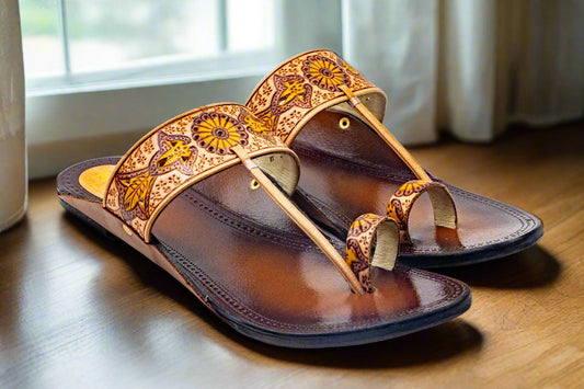 Brown sandal with decorative straps on a light gray background