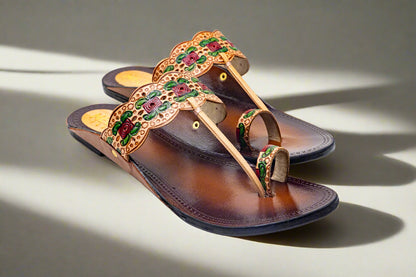 Elegant handcrafted brown leather flats with scalloped floral carving and multicolor embossed rose design by Mellow Feets, perfect for festive and ethnic wear.