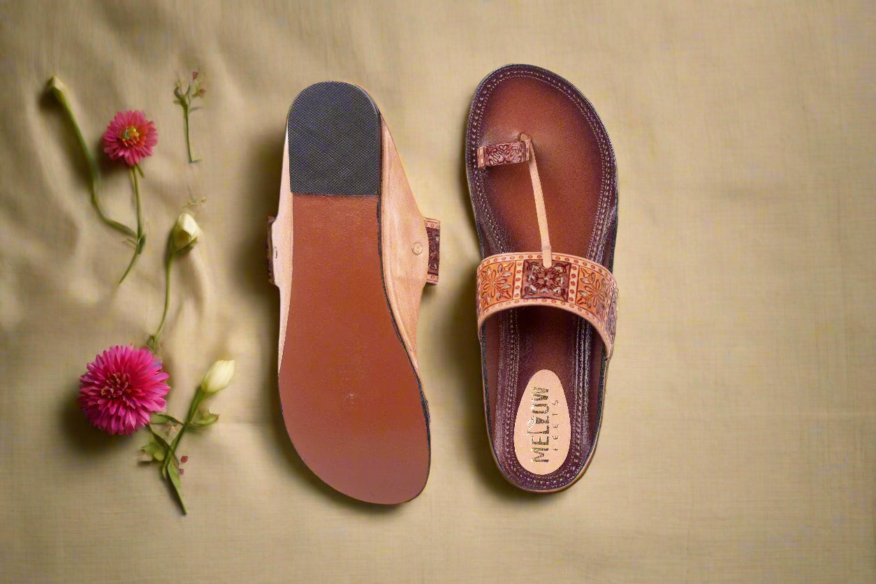 Brown sandal with a decorative strap on a white background