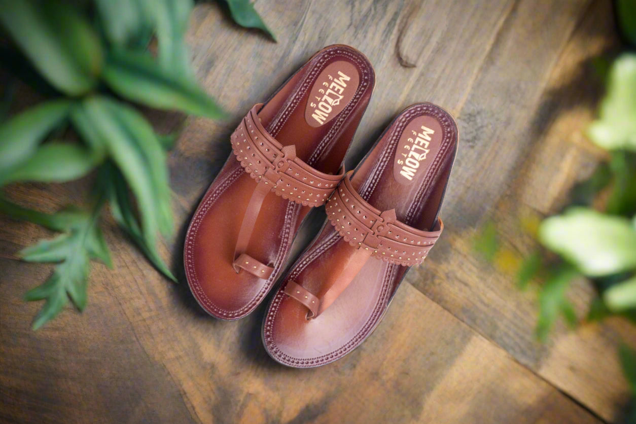 Pair of brown sandals with 'Mott' branding on a white background