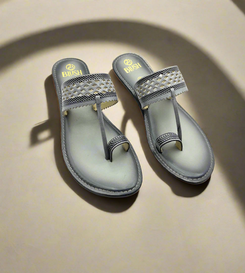 Grey handcrafted Kolhapuri sandals by Mellow Feets with laser-cut lattice design strap, stitched toe loop, and ethnic flat sole for women
