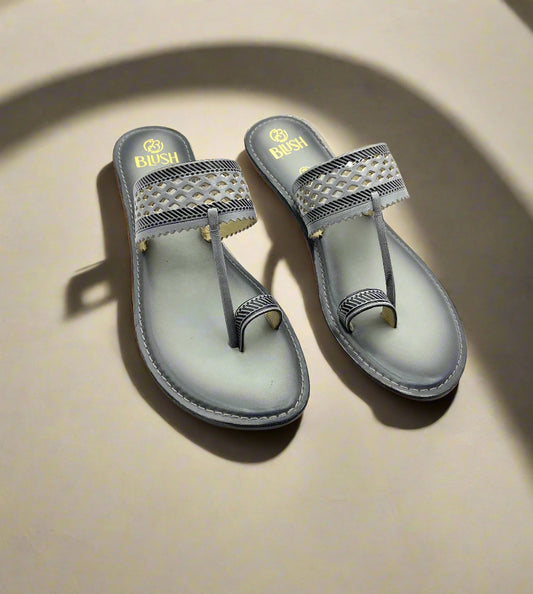 Grey handcrafted Kolhapuri sandals by Mellow Feets with laser-cut lattice design strap, stitched toe loop, and ethnic flat sole for women