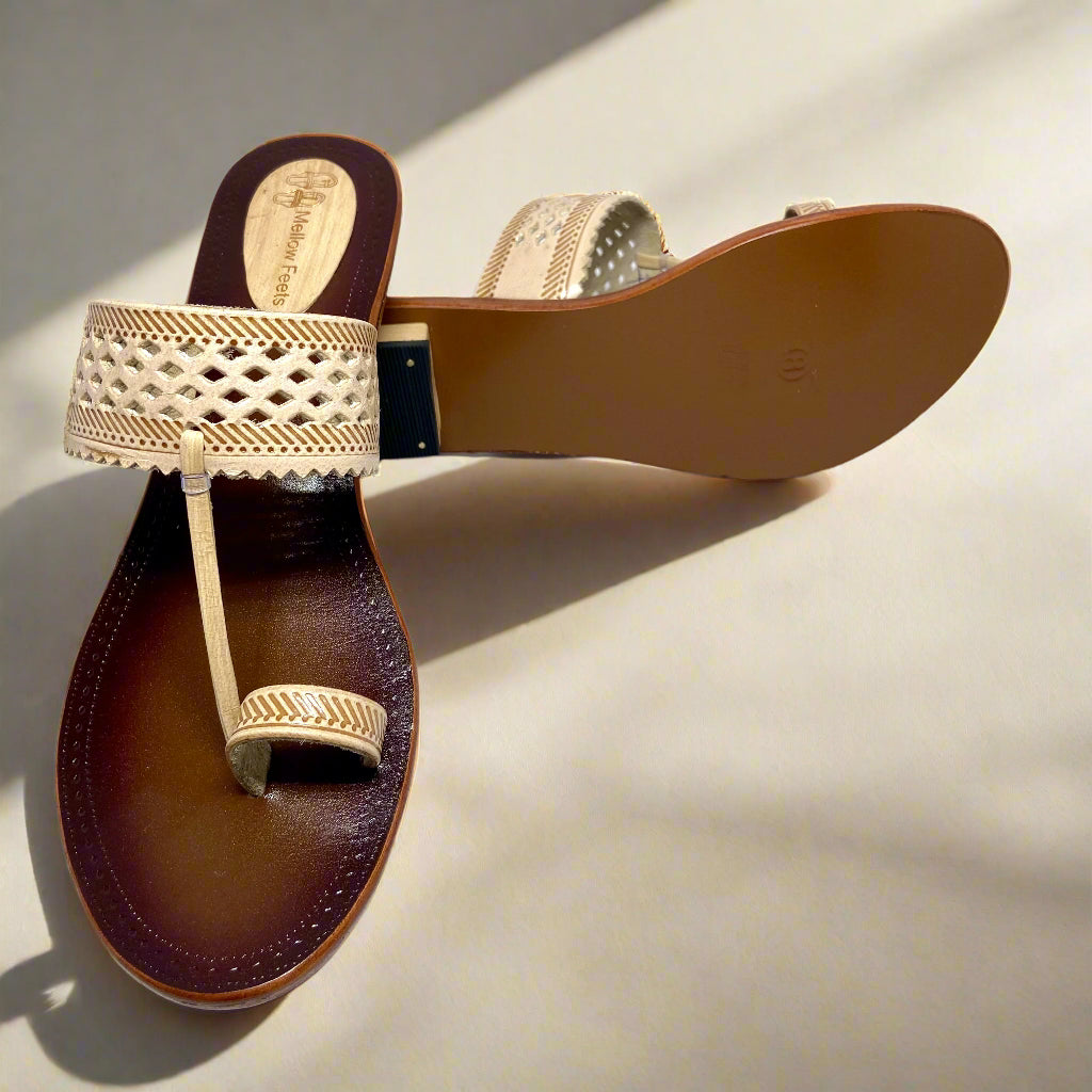Beige handcrafted Kolhapuri flats for women with cutwork leather strap and toe ring design on brown cushioned sole – Mellow Feets ethnic footwear