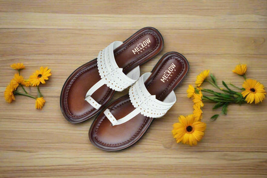 Top view of handcrafted white leather Kolhapuri flats by Mellow Feets on a clean background